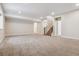 Large finished basement with neutral carpet, staircase, and multiple rooms at 13986 Lexington Dr, Parker, CO 80134