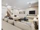 Finished basement with ample seating, a large TV, and a staircase leading upstairs at 13986 Lexington Dr, Parker, CO 80134