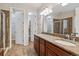 Bathroom offers a double vanity with granite countertops, a separate toilet, and a walk-in shower at 13986 Lexington Dr, Parker, CO 80134