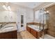Bathroom features double sinks, a soaking tub, and a glass-enclosed shower at 13986 Lexington Dr, Parker, CO 80134
