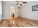 Bedroom features hardwood floors and access to a private bathroom at 13986 Lexington Dr, Parker, CO 80134