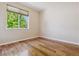 Bedroom features a large window with views of the surrounding trees and greenery at 13986 Lexington Dr, Parker, CO 80134