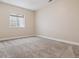 Bedroom features neutral carpet and window for natural light at 13986 Lexington Dr, Parker, CO 80134