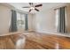 Bright bedroom features hardwood floors, a ceiling fan, and large windows for natural light at 13986 Lexington Dr, Parker, CO 80134