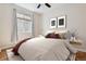Cozy bedroom with a soft color pallete, modern art, and large window with bright sunlight at 13986 Lexington Dr, Parker, CO 80134