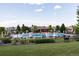 Community pool featuring a lounge area, tables, and seating, all enclosed by an iron fence at 13986 Lexington Dr, Parker, CO 80134