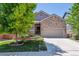 Charming home featuring stone accents, a well-manicured lawn, and a spacious two-car garage at 13986 Lexington Dr, Parker, CO 80134