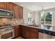 Chef's kitchen with stainless steel appliances, granite counters, and ample natural light at 13986 Lexington Dr, Parker, CO 80134