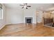 Bright living room with hardwood floors, a fireplace with stone surround, and a ceiling fan at 13986 Lexington Dr, Parker, CO 80134