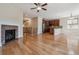 Open-concept living space featuring hardwood floors, a cozy fireplace, and abundant natural light at 13986 Lexington Dr, Parker, CO 80134
