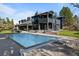 Stunning backyard featuring a large pool and modern architectural design of the house at 1 Sedgwick Dr, Cherry Hills Village, CO 80113