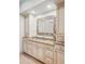 Elegant bathroom vanity with granite countertop, custom mirror and cabinetry at 1 Sedgwick Dr, Cherry Hills Village, CO 80113