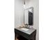 Modern powder room with sleek vanity, black faucet, and unique pendant lighting fixtures at 1 Sedgwick Dr, Cherry Hills Village, CO 80113