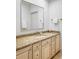 Bathroom vanity featuring granite countertop and a large mirror at 1 Sedgwick Dr, Cherry Hills Village, CO 80113