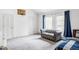 Bright, minimalist bedroom featuring a tufted gray sofa and basketball hoop at 1 Sedgwick Dr, Cherry Hills Village, CO 80113