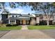 Contemporary home showcasing dark brick, stylish windows, modern lighting, and a meticulously maintained lawn at 1 Sedgwick Dr, Cherry Hills Village, CO 80113