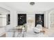 Bright living room featuring elegant decor, sleek black bookshelves, and a glass desk at 1 Sedgwick Dr, Cherry Hills Village, CO 80113