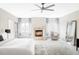 Serene main bedroom with a fireplace, soft carpet, and bright windows with drapes at 1 Sedgwick Dr, Cherry Hills Village, CO 80113