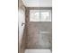 Tiled shower with sleek fixtures, a built-in bench, and a window at 1 Sedgwick Dr, Cherry Hills Village, CO 80113