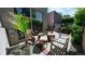 Relax on this charming back patio with wicker seating, lush greenery, and a tranquil atmosphere at 396 E Warren Ave, Denver, CO 80210