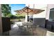 Enjoy outdoor dining under a striped umbrella on this spacious patio with metal table and chairs at 396 E Warren Ave, Denver, CO 80210