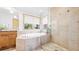 Bright bathroom with a glass-enclosed shower, a separate soaking tub, and natural light at 396 E Warren Ave, Denver, CO 80210