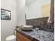 Stylish bathroom with a vessel sink and artistic mosaic tile backsplash on the countertop at 396 E Warren Ave, Denver, CO 80210