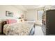 Bright bedroom featuring two twin beds, a large wardrobe, and a sunlit window at 396 E Warren Ave, Denver, CO 80210