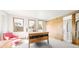Bright bedroom with three windows, a wooden bed, and unique sliding door design at 396 E Warren Ave, Denver, CO 80210