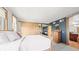 Bedroom with a sliding closet door, wood floors, and a view into the bathroom at 396 E Warren Ave, Denver, CO 80210