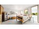Bright bedroom with natural light, a wooden bed, and eclectic decor at 396 E Warren Ave, Denver, CO 80210