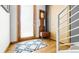 Cozy entryway with hardwood floors, decorative bench, and modern doorway at 396 E Warren Ave, Denver, CO 80210