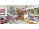 Open living space with hardwood floors, modern staircase, and kitchen access at 396 E Warren Ave, Denver, CO 80210
