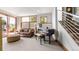 Cozy living room with carpet floors, lots of windows, and a baby grand piano at 396 E Warren Ave, Denver, CO 80210