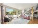 Bright living room with large windows, hardwood floors, and an open staircase at 396 E Warren Ave, Denver, CO 80210
