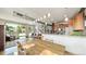 Open-concept living space combining kitchen, dining, and living areas with abundant natural light at 396 E Warren Ave, Denver, CO 80210