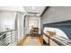 Open concept office with industrial ductwork in the ceiling and a classic wooden desk setup at 396 E Warren Ave, Denver, CO 80210