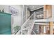 Bright staircase with industrial ductwork that passes above the landing and flanks the side of the stairs at 396 E Warren Ave, Denver, CO 80210
