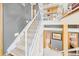 Modern staircase showcasing carpeted treads, sleek design and industrial ductwork at 396 E Warren Ave, Denver, CO 80210