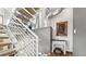 Modern staircase with carpeted steps, industrial ductwork, and decor at 396 E Warren Ave, Denver, CO 80210