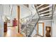 Modern staircase featuring metal railing, carpet treads, and open floor plan at 396 E Warren Ave, Denver, CO 80210