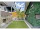 Backyard featuring artificial grass and exterior green wall with neon sign at 3540 Pecos St, Denver, CO 80211