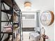 Bright bonus room features stylish ladder bookshelf, chair with ottoman and large decorative clock at 3540 Pecos St, Denver, CO 80211