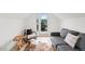 Cozy bonus room with wood floors, gray couch and chair with balcony access at 3540 Pecos St, Denver, CO 80211