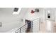 Hallway with railing leads to bonus room featuring a bar and balcony access at 3540 Pecos St, Denver, CO 80211