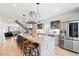 Bright, modern kitchen with large island, stainless steel appliances, and open staircase at 3540 Pecos St, Denver, CO 80211