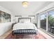 Spacious main bedroom with a king-sized bed, stylish rug, and balcony at 3540 Pecos St, Denver, CO 80211