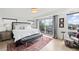 Bright main bedroom with a large bed, balcony access, and modern decor at 3540 Pecos St, Denver, CO 80211