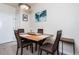 Small dining area with four chairs and a wood table at 4100 Albion St # 501, Denver, CO 80216