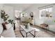 Bright living room featuring neutral decor, hardwood floors, and a view into the dining and entryway at 3251 N Madison St, Denver, CO 80205